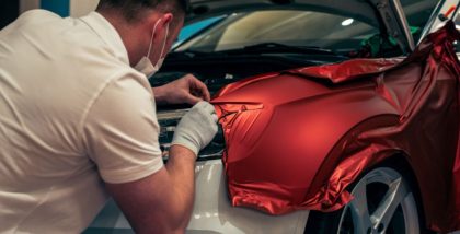 A mechanic is applying different types of car wraps