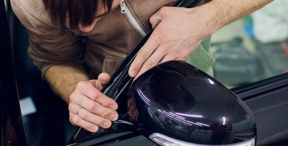 a person is checking Electric mirror problems in cars