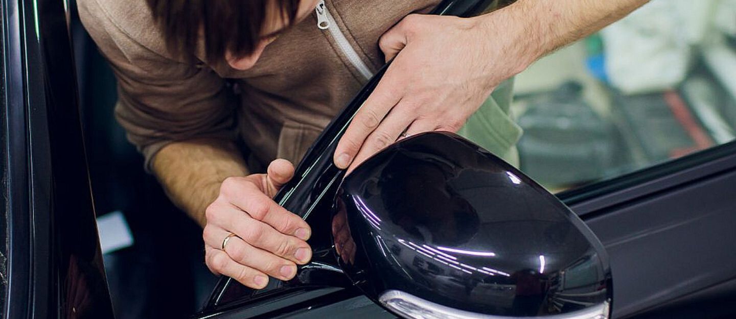 a person is checking Electric mirror problems in cars