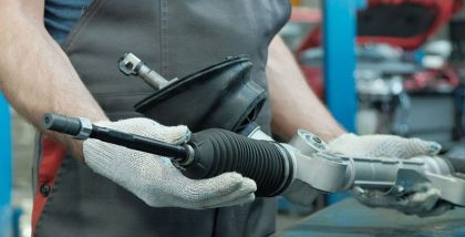 a man checking signs of rack and pinion steering replacement