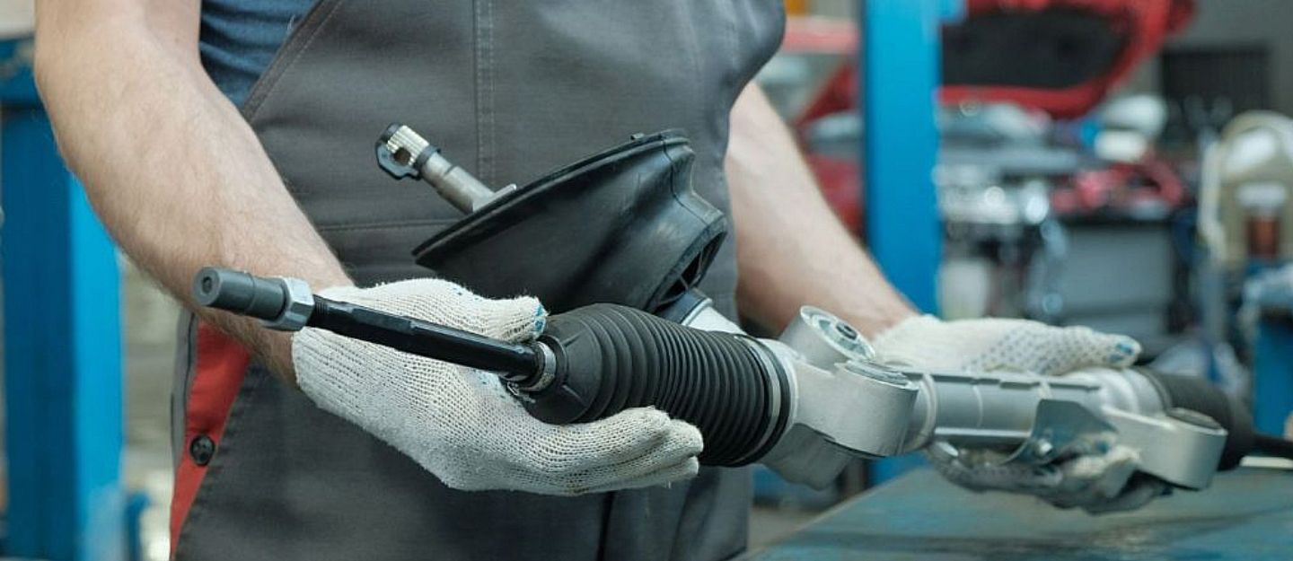 a man checking signs of rack and pinion steering replacement