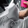 a person is applying self-healing car paint