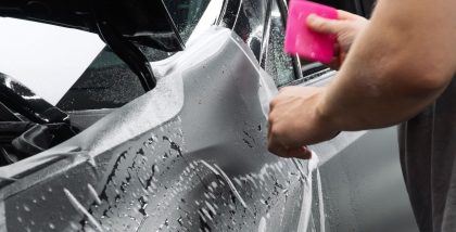 a person is applying self-healing car paint