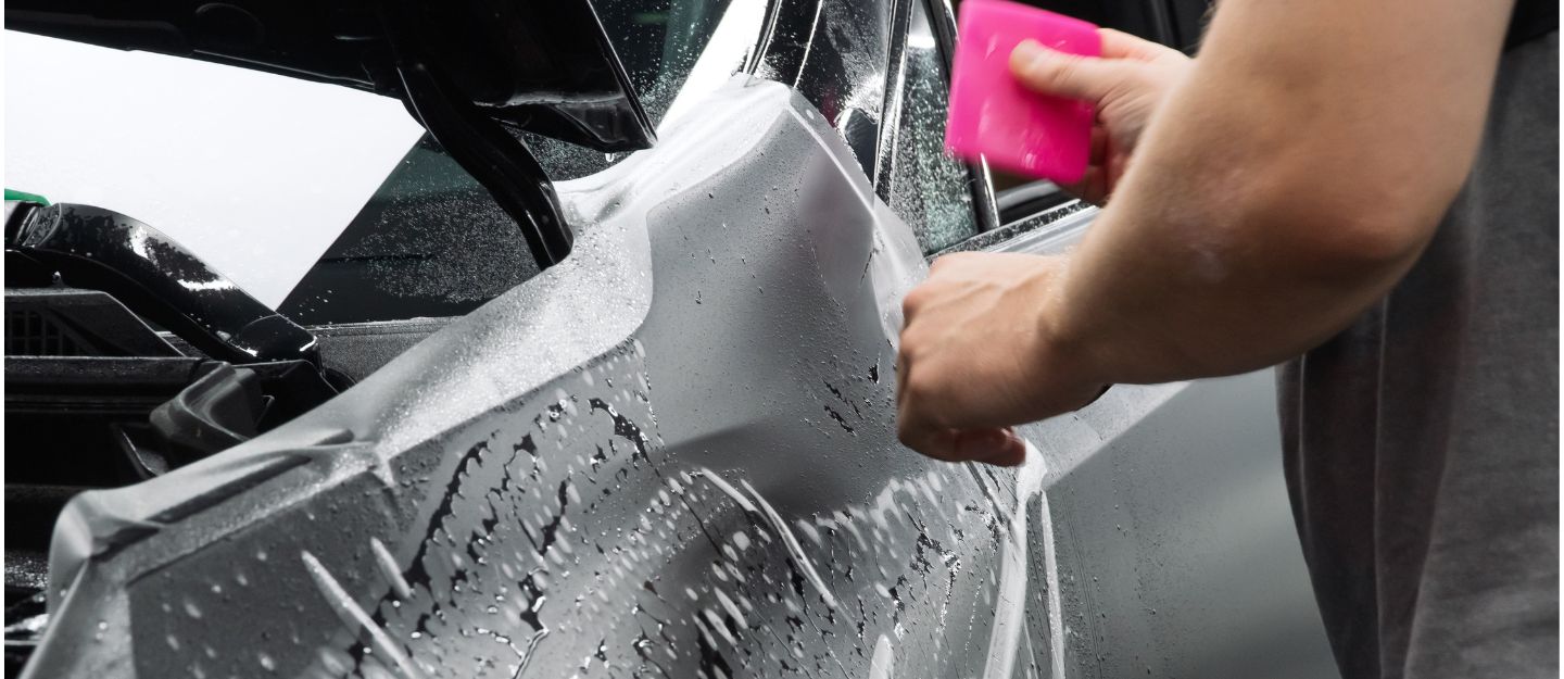 a person is applying self-healing car paint