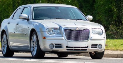 A 2008 silver Chrysler 300 car driving on the road. Image Credits: Shutterstock Contributor Sue Thatcher