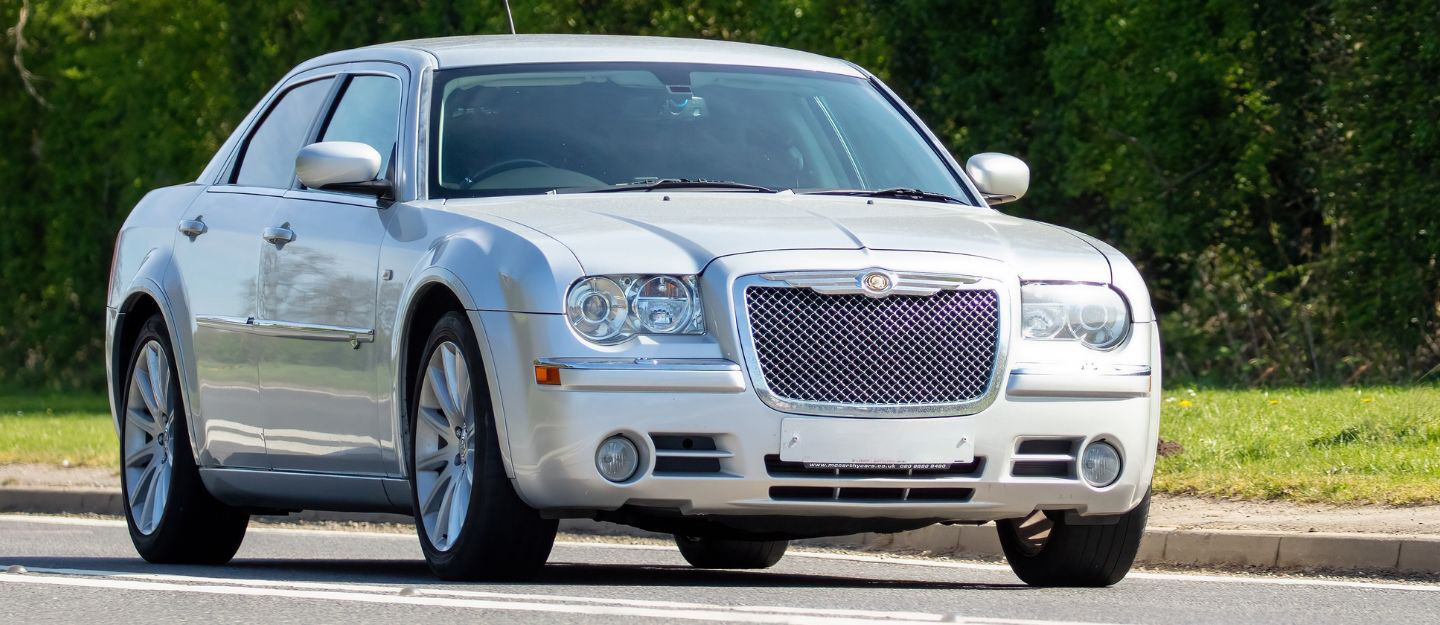 A 2008 silver Chrysler 300 car driving on the road. Image Credits: Shutterstock Contributor Sue Thatcher