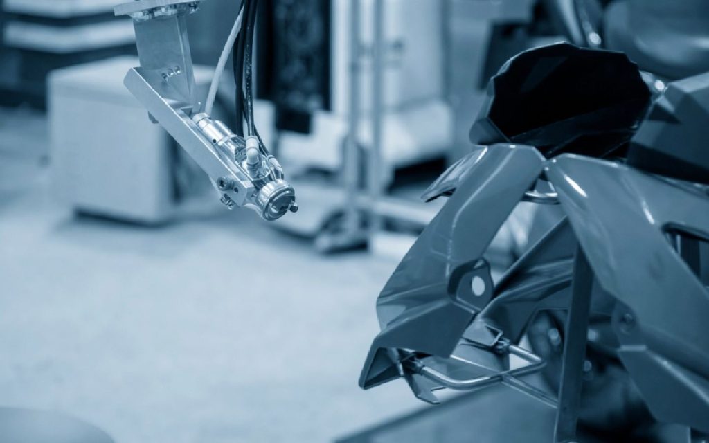 Close-up shot of the automated paint application system