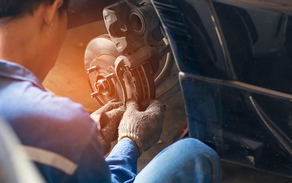 Man working on car brakes.