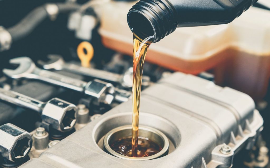 a person adding coolant in engine