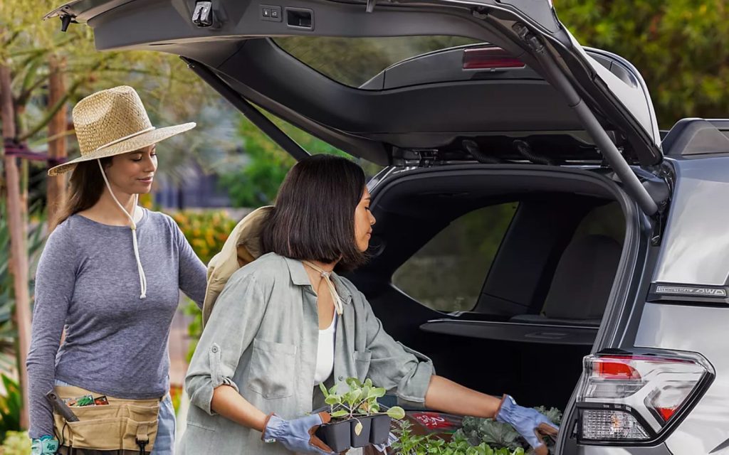 two girls taking out plants form the Electric liftgate