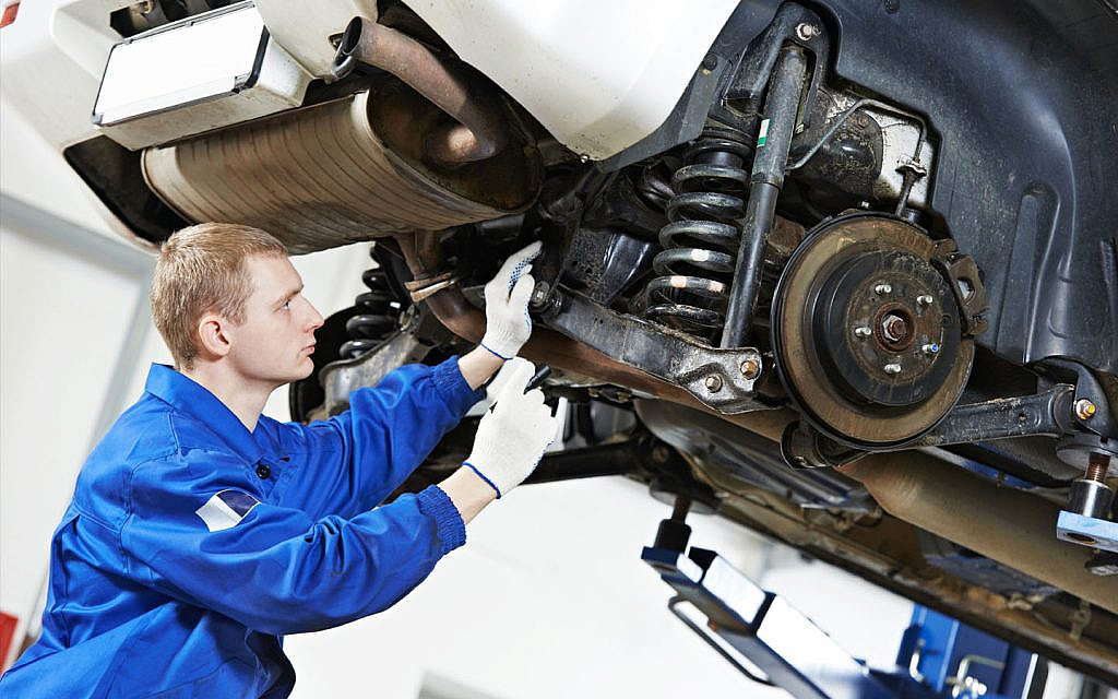 Man inspecting a vehicle